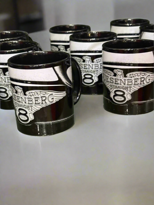 Black and white mugs with 'Duesenberg 8' branding on a reflective surface.