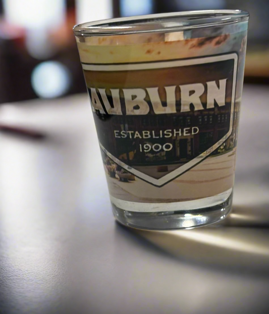 Shot glass with 'Auburn' branding on a white surface